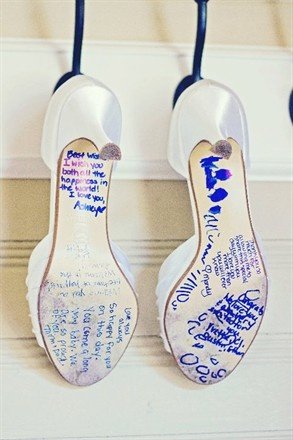 People that mean the most to the bride write a short message on the bottom of her shoes (in blue, or the "something blue"). Definitely want to do this for my wedding!